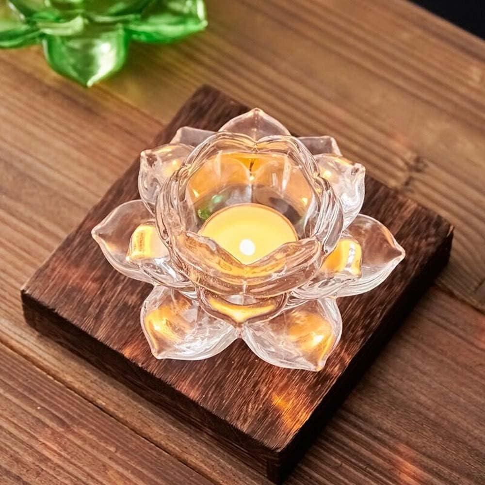 Clear glass lotus flower candle holder with a lit candle